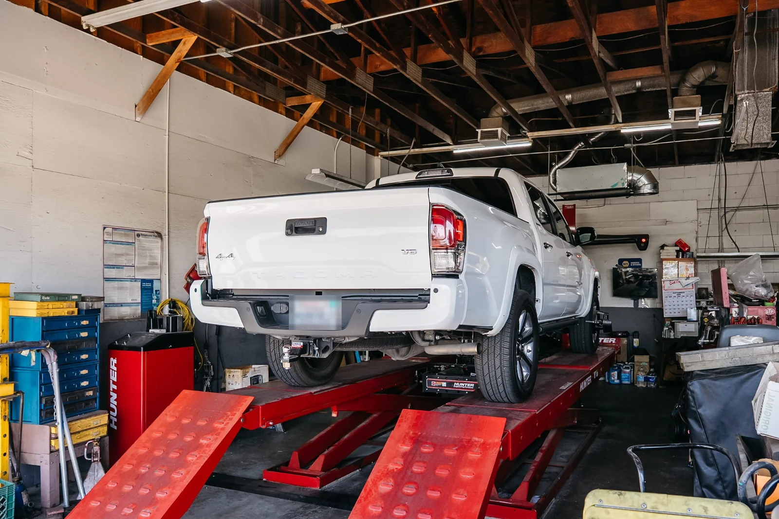 White Toyota Tacoma on the Hunter alignment rack in the mechanical bay